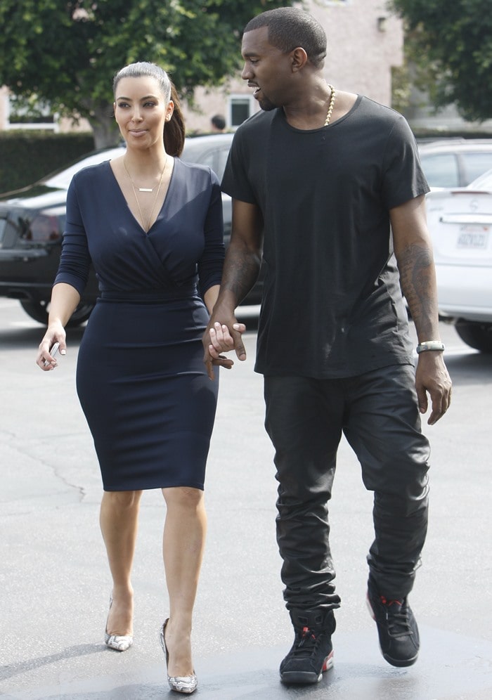 Kim Kardashian stuns in a navy wrap dress paired with snakeskin heels, while Kanye West keeps it effortlessly cool in an all-black casual ensemble with leather pants and high-top sneakers