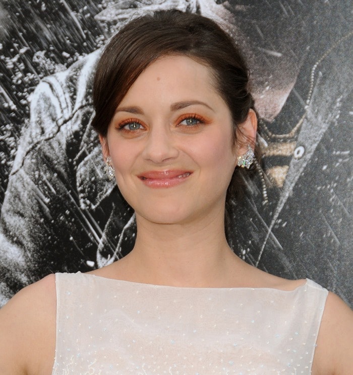 Warm copper eyeshadow and glossy nude lips soften Marion Cotillard’s polished premiere beauty look