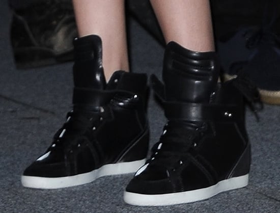 Kristen Stewart in Barbara Bui leather sneakers Kristen Stewart elevates her Comic-Con look with Barbara Bui's signature hidden wedge-heel sneakers, combining comfort with height-boosting style
