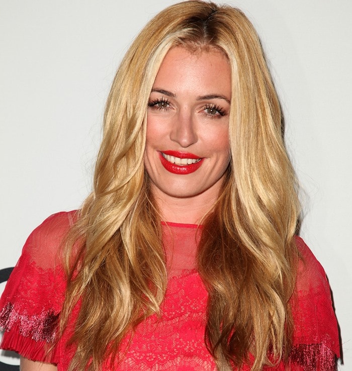 Cat Deeley’s hairstyle features long, voluminous waves with a center part, perfectly framing her face and adding to her effortlessly glamorous look