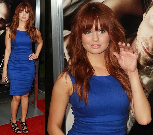 Debby Ryan stunned in a figure-hugging blue Nicole Miller dress paired with Jerome C. Rousseau “Tesla” sandals and a Kotur box minaudière at the premiere of The Words