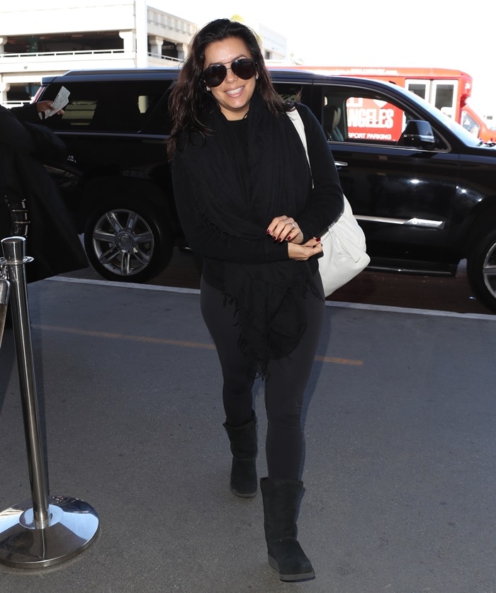 Eva Longoria flashed a cheerful smile as she maked her way into LAX Airport in Los Angeles on December 1, 2017