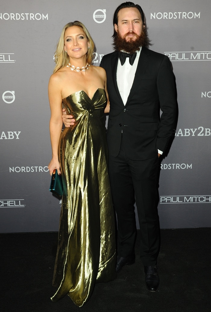Kate Hudson and Danny Fujikawa attend the 2019 Baby2Baby Gala in Los Angeles, with Hudson shining in a gold Prada gown paired with matching Giuseppe Zanotti platform sandals