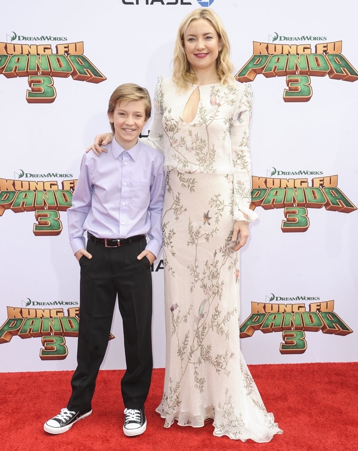 Joined by her firstborn, Ryder Russell Robinson, Kate Hudson steps onto the red carpet at the Kung Fu Panda 3 premiere in a Monique Lhuillier gown paired with reflective Jimmy Choo platform heels