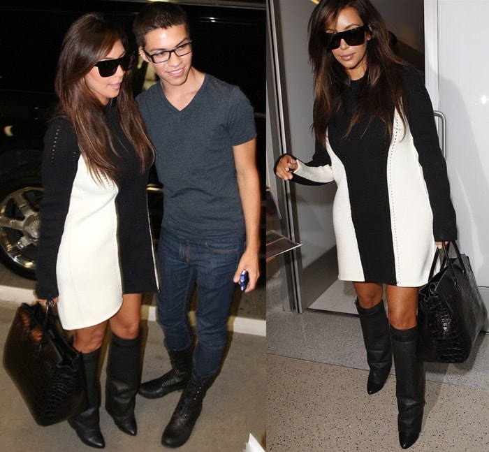 Kim Kardashian poses with a fan at Los Angeles International Airport