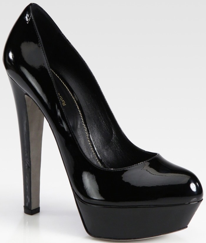 Sergio Rossi black patent leather platform pumps featuring a rounded toe, glossy finish, and towering stiletto heel — a leg-lengthening classic priced at $650