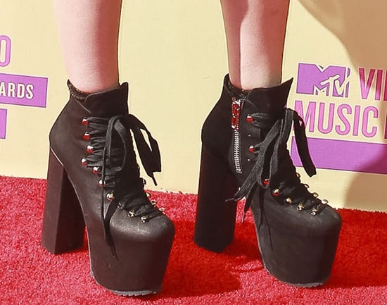 Kreayshawn 2012 MTV Video Music Awards A close-up captures her towering black lace-up platform boots, where chunky heels and hardware details bring a rebellious finish to the look