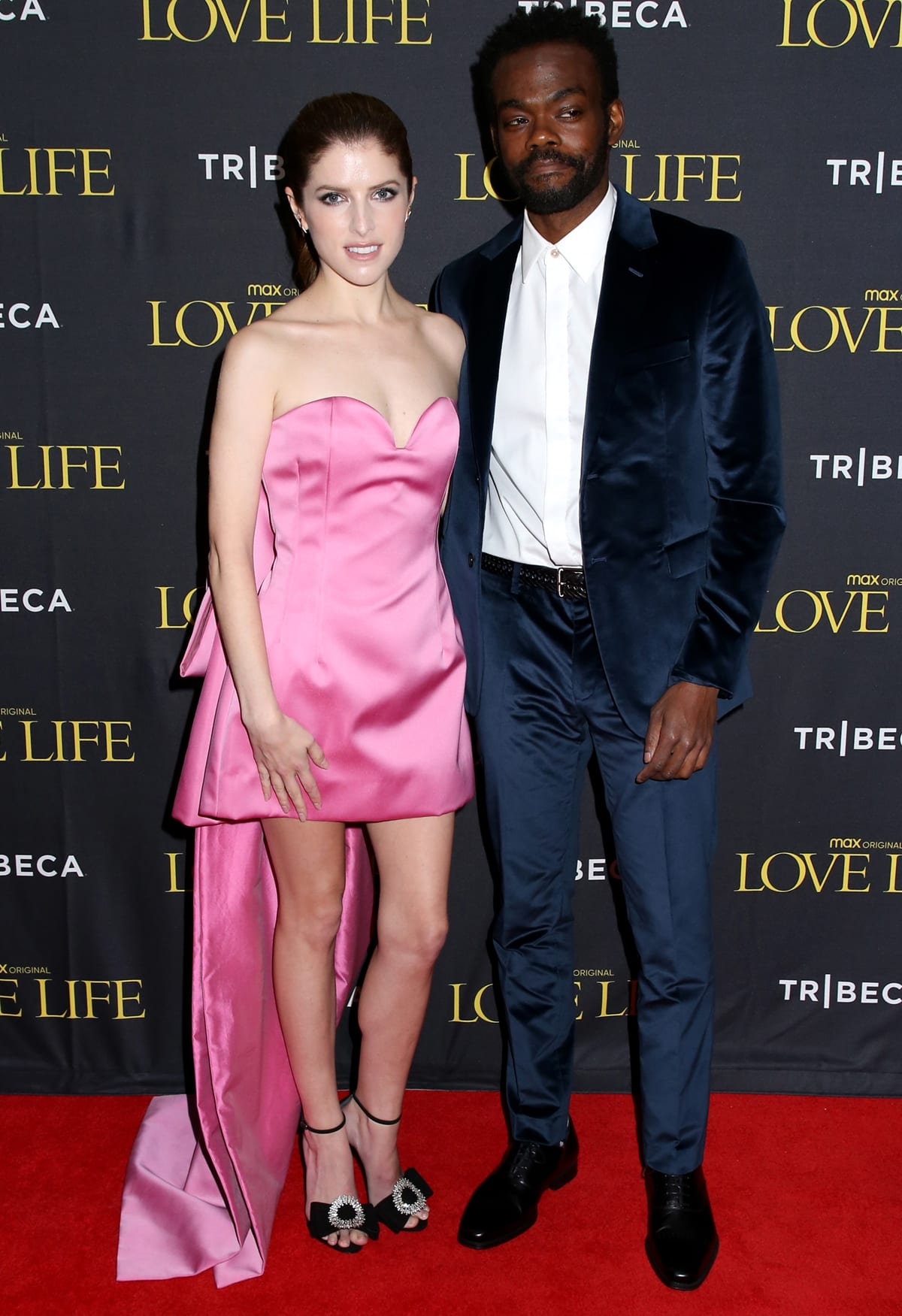 Anna Kendrick and William Jackson Harper attend the Love Life Season 2 premiere at New York’s DGA Theater, with Kendrick stunning in a strapless pink Lanvin Fall 2021 mini dress and Alexandre Birman “Maddie” crystal-embellished suede sandals