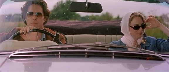 Renée Zellweger in a head scarf in Bridget Jones' Diary Bridget Jones (Renée Zellweger) looks gleeful in her headscarf on her ride to the country with Daniel Cleaver (Hugh Grant)