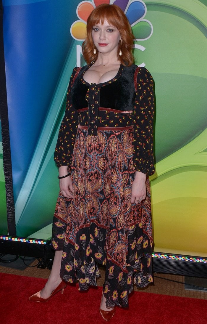 Christina Hendricks stuns in a bohemian-inspired printed dress with velvet details and metallic pointed-toe heels at NBC’s New York 2019 Mid-Season Press Junket