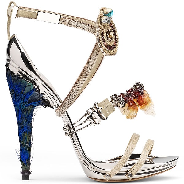 Gianluca Tamburini Maya Gianluca Tamburini’s Maya sandal combines raw crystals, tribal beading, and a peacock-feather-wrapped heel—crafted for maximum visual and textural contrast