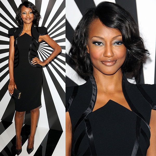 Nichole Galicia exudes elegance in a structured black dress with satin detailing, paired with pointed Jimmy Choo 'Anouk' pumps from the Rob Pruitt collection