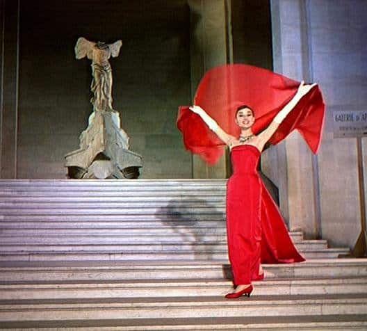 Audrey Hepburn with red scarf in Funny Face Jo Stockton (Audrey Hepburn) glides down the Daru steps, holding a red scarf above her head in the film Funny Face