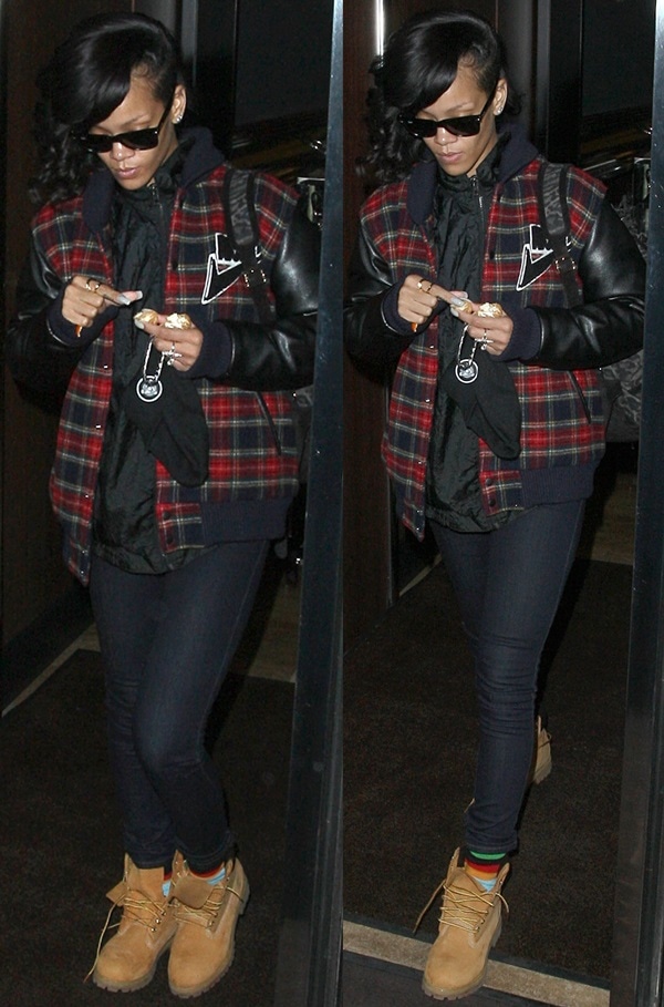Rihanna was spotted exiting her London hotel on November 28, 2012, grounding her red-and-black Joyrich Freshman varsity jacket, skinny jeans, and Ray-Ban Wayfarer sunglasses with Timberland Premium Boots in wheat nubuck, finished with a leopard-print suede backpack by Pierre Hardy