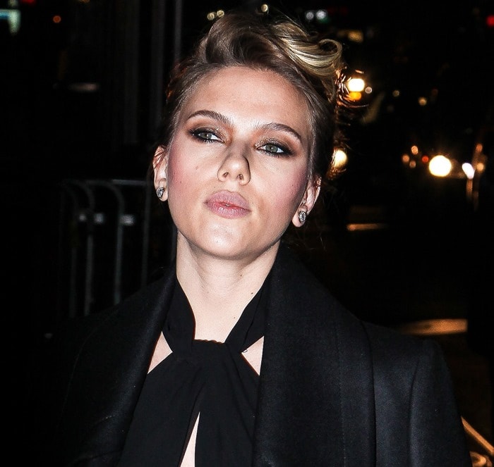 The actress highlights her sculpted features with bronzed eye makeup and a soft nude lip, adding polish to her monochrome look