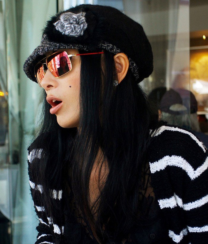 Bai Ling tops her dark hair with a hat as she arrives at Villa Blanca restaurant