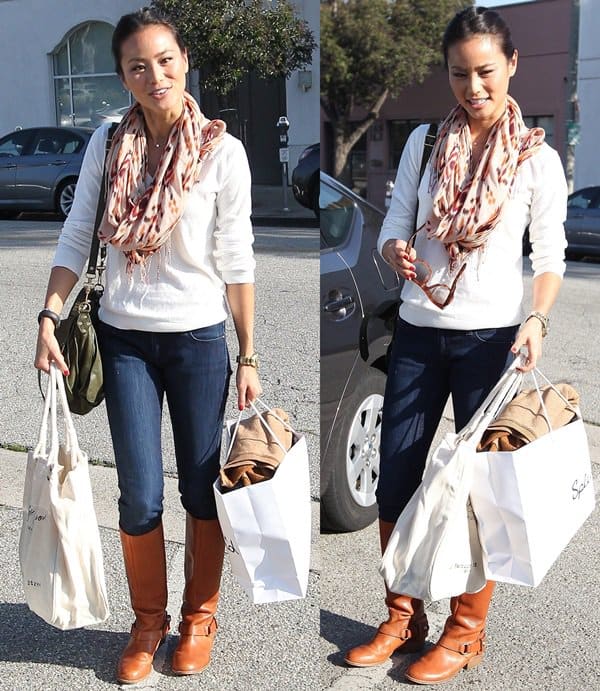 Jamie Chung was seen carrying a stylish Proenza Schouler PS1 Large leather bag with her outfit, which included a casual sweater, jeans, and knee-high boots, completing a sleek and effortless look