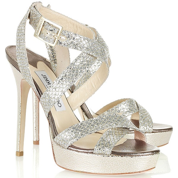 Jimmy Choo “Vamp” metallic snake-embossed lamé platform sandals, originally retailing at $750, feature crisscross glitter straps, a sculpted 5.5-inch stiletto heel, and a supportive front platform that balances height with wearability