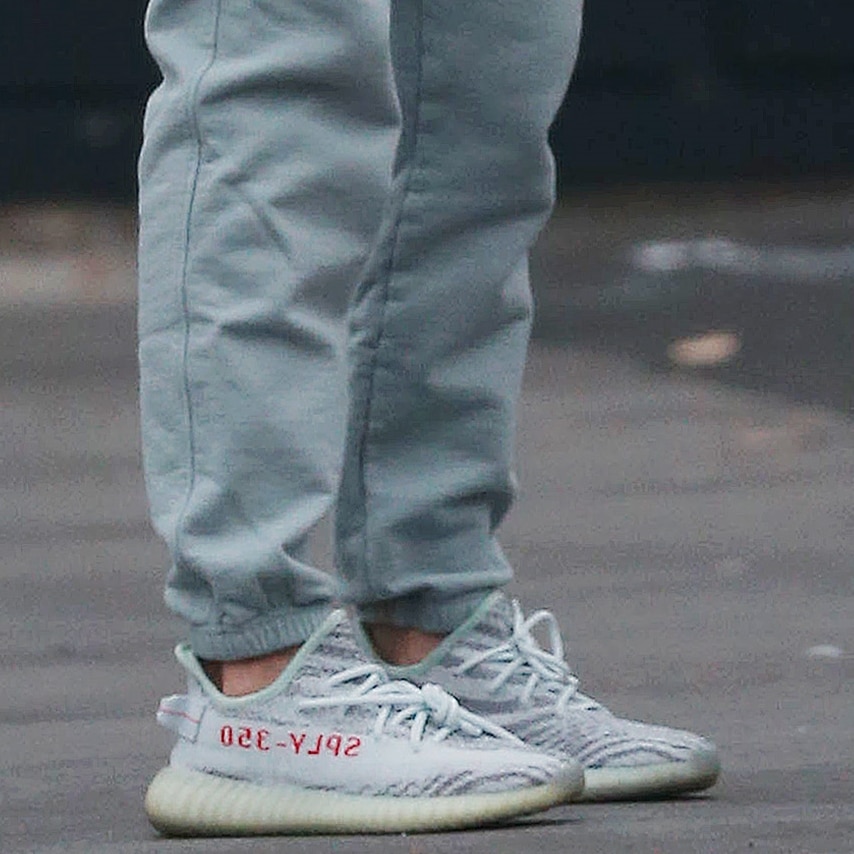 A closer look at the Yeezy Boost 350 V2 “Beluga 2.0” reveals the signature grey Primeknit upper and bold orange “SPLY-350” stripe that defined the silhouette’s late-2010s peak