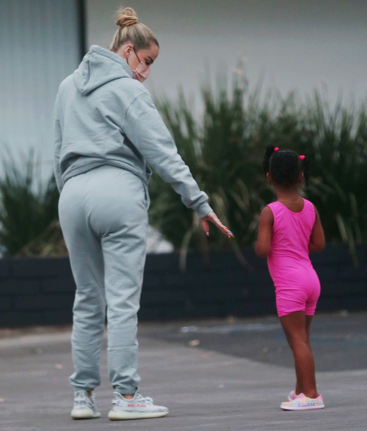 Khloé Kardashian steps out in a muted grey sweatsuit, letting her Yeezy Boost 350 V2 “Beluga 2.0” sneakers add a subtle hit of contrast as she walks her daughter to dance class in Los Angeles