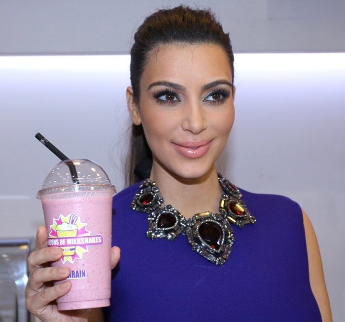 Kim Kardashian promotes her signature milkshake at a Millions of Milkshakes event in Bahrain, showcasing her chic style with a statement Lanvin necklace