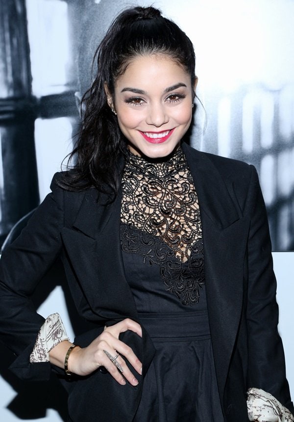 She finished the look with a sleek high ponytail, softly defined makeup, a Cartier Love bracelet, and delicate rings—letting polished accessories and clean styling complement the lace detailing without overpowering it