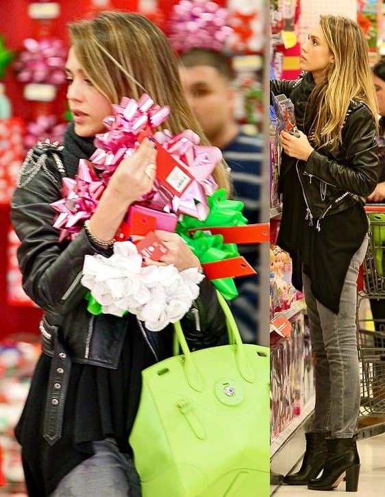 Jessica Alba shops for Christmas gifts at Target in Current/Elliott grey star-print skinny jeans and sleek black ankle boots, layering a cozy infinity scarf under a studded leather jacket and carrying a bold lime Ralph Lauren Soft Ricky bag