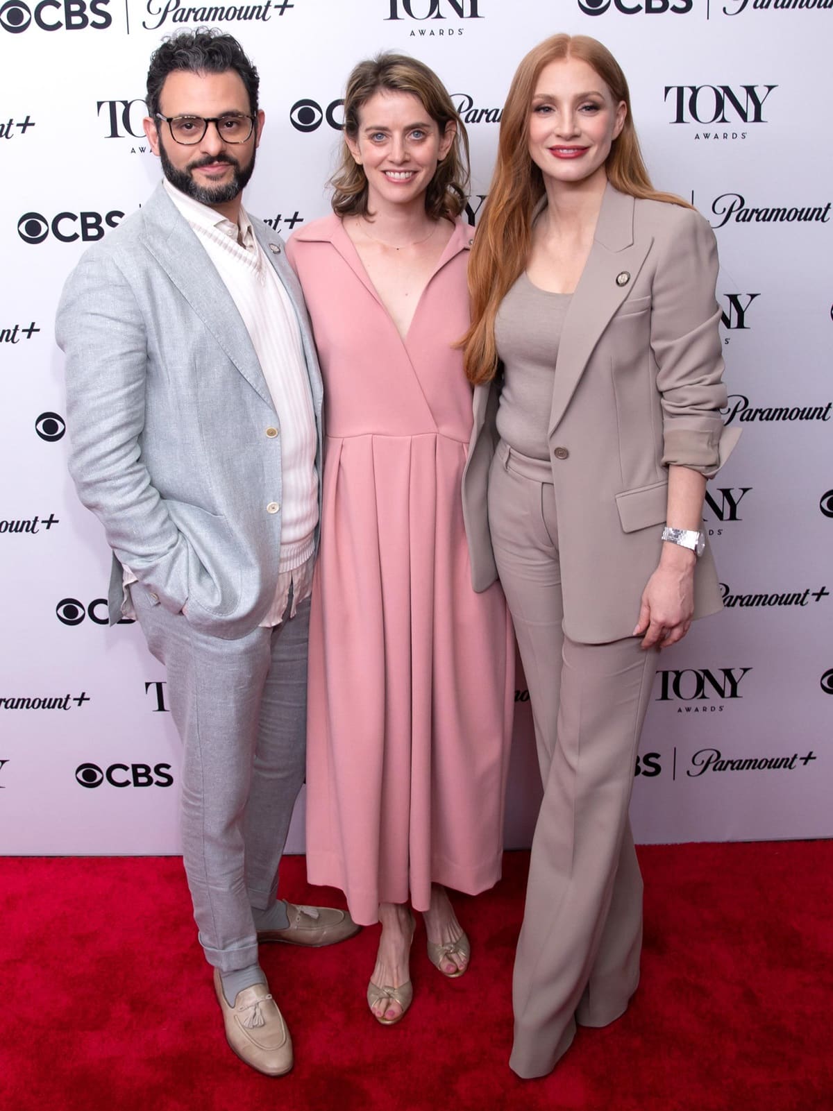 Arian Moayed, Amy Herzog, and Jessica Chastain attend the 76th Annual Tony Awards Meet the Nominees press event at Sofitel New York on May 4, 2023, with Chastain exuding effortless sophistication in a taupe Michael Kors suit paired with matching flared trousers and neutral pointed-toe heels