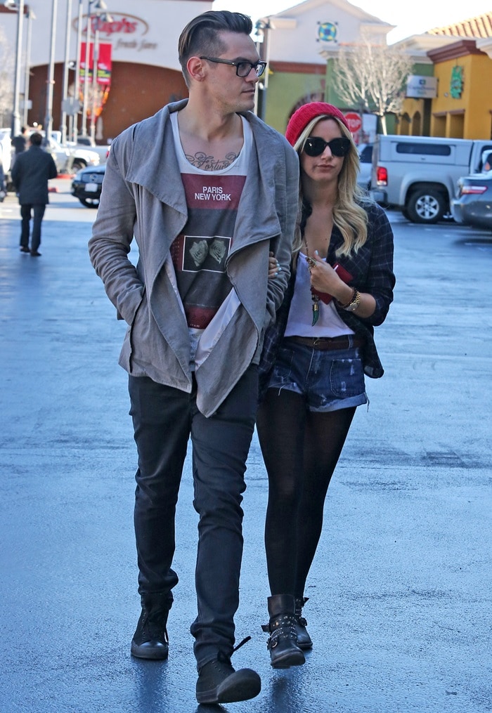 Ashley Tisdale and Christopher French were spotted heading to Rite Aid in Los Angeles, California, on January 18, 2013, with Ashley wearing a blue sweater, jeans, and brown boots, and Christopher in a black and white jacket, jeans, and sneakers