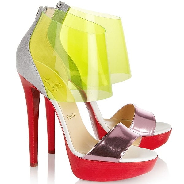 The neon-tinted PVC version of the Christian Louboutin “Dufoura” sandal combines a translucent lime ankle wrap with metallic leather straps and a bold red platform sole for a futuristic statement finish