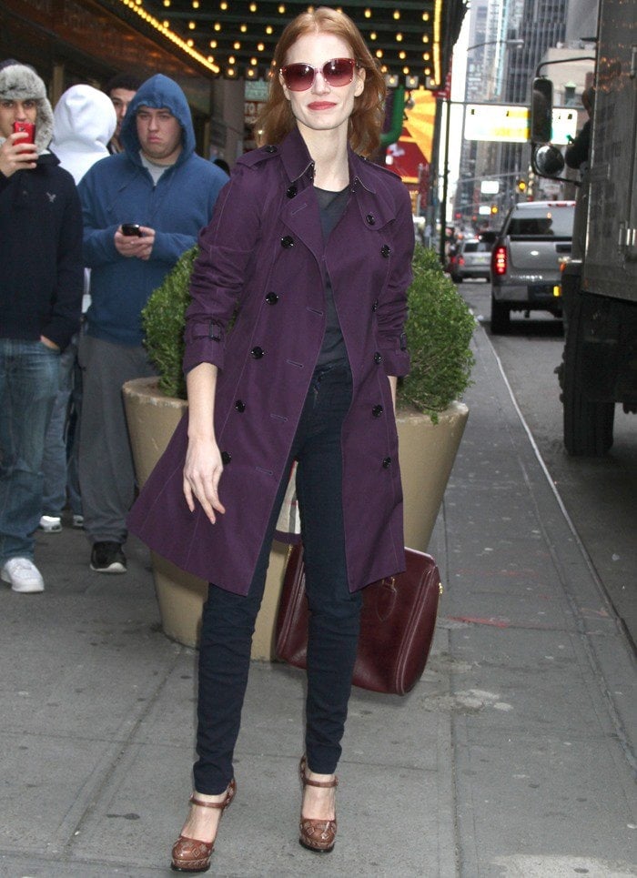 Stepping out with effortless polish, Jessica Chastain pairs her tailored purple coat with slim navy jeans and oversized sunglasses for a sleek daytime look