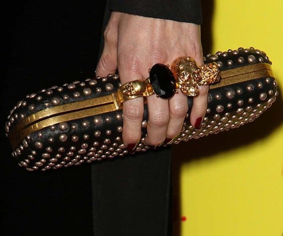 Close-up of Ricki Noel Lander's Alexander McQueen clutch, showcasing its intricate stud and skull details