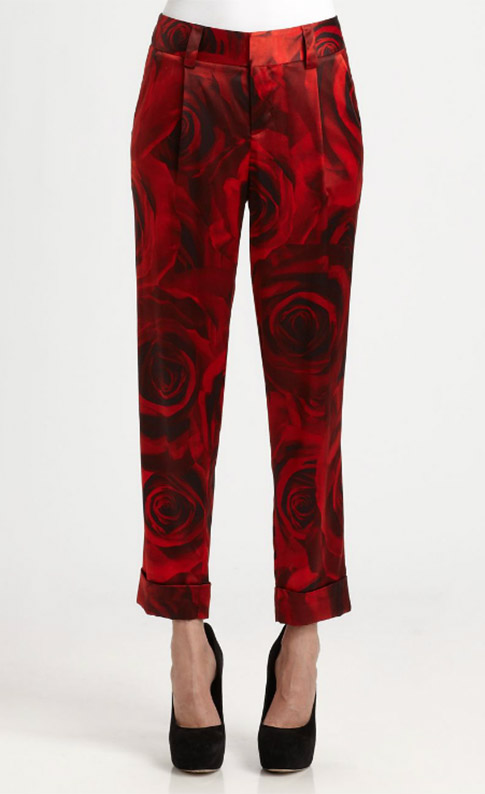 Alice + Olivia’s ‘Arthur’ red floral pants feature a romantic rose-print design with a tailored, ankle-length silhouette that balances statement impact with polished versatility