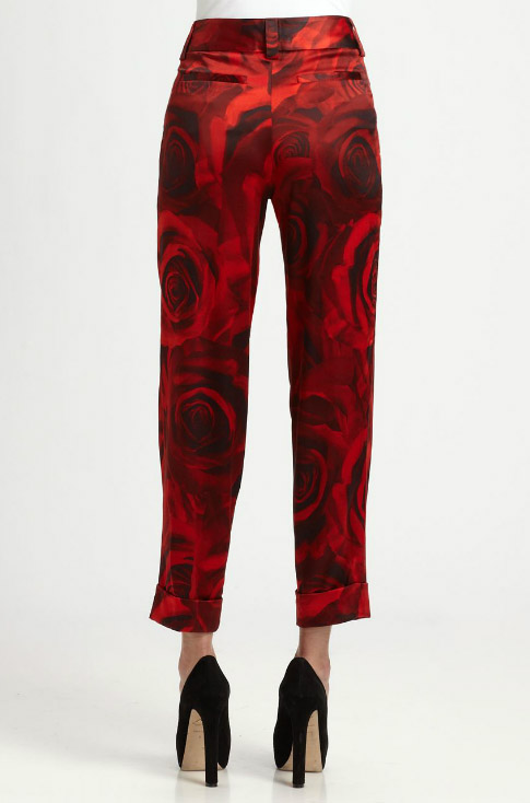 Alice + Olivia’s ‘Arthur’ red floral pants feature a romantic rose-print design with a tailored, ankle-length silhouette that balances statement impact with polished versatility