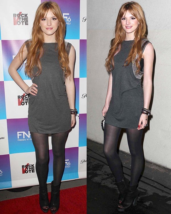 Bella Thorne shows off her edgy style in black peep-toe booties that elevate her simple gray mini and sheer tights