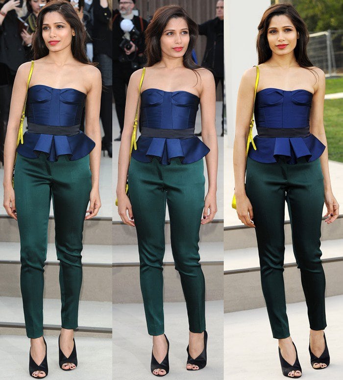 Freida Pinto stuns in a strapless navy peplum top and emerald green skinny trousers, finishing the look with sleek black Burberry peep-toe wedges and a pop of color from a yellow shoulder bag