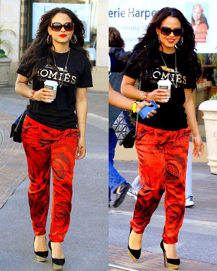 Christina Milian anchors her casual shopping look with towering Charlotte Olympia platform pumps, pairing the statement heels with a black graphic tee and red floral Alice + Olivia pants at The Grove in Los Angeles on February 13, 2013