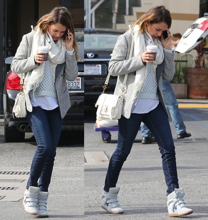 Jessica Alba keeps it casual yet chic in star-embellished Isabel Marant wedge sneakers, skinny jeans, a knit sweater layered over a white tee, and a gray blazer, finishing her look with a white scarf and a Proenza Schouler PS1 Pouch