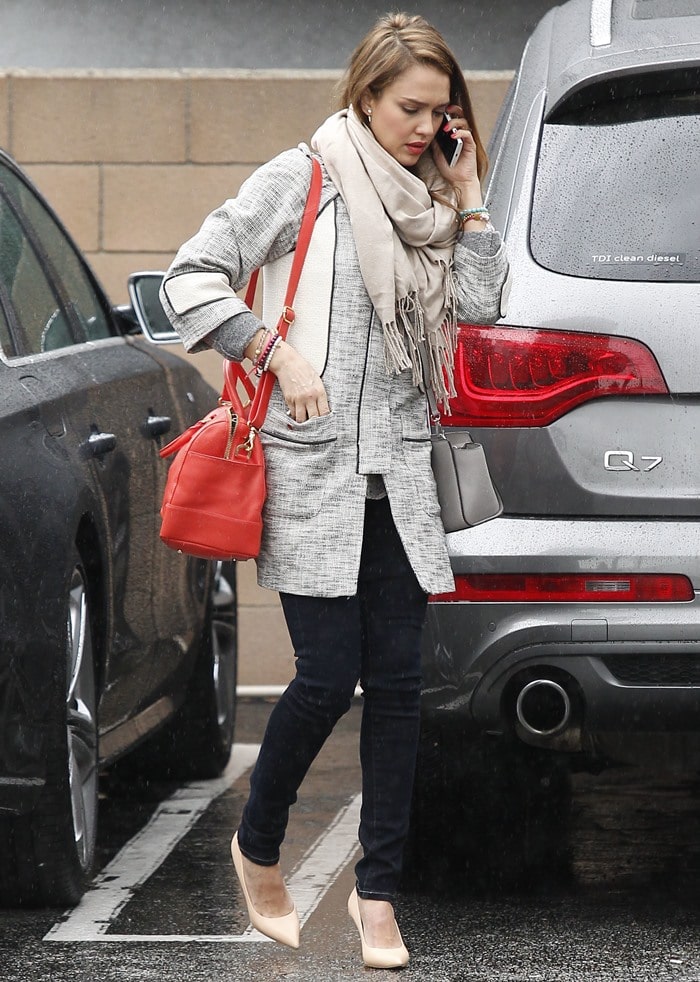 Jessica Alba paired her heels with dark denim skinnies, a textured coat by HM, a cozy wrap scarf, and a bright red Tory Burch satchel bag