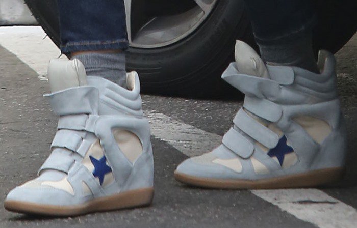 Close-up of Jessica Alba’s Isabel Marant “Bayley” wedge sneakers in light blue suede, featuring bold star embellishments and a hidden heel