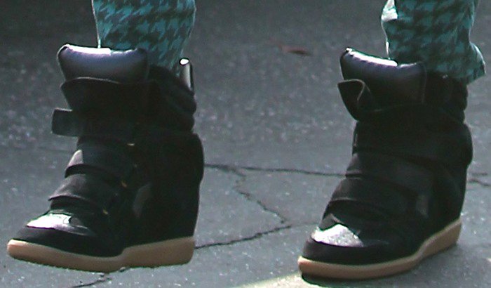 A closer look at Jessica Alba’s black Isabel Marant “Bekett” wedge sneakers, crafted in suede with a hidden heel and Velcro straps