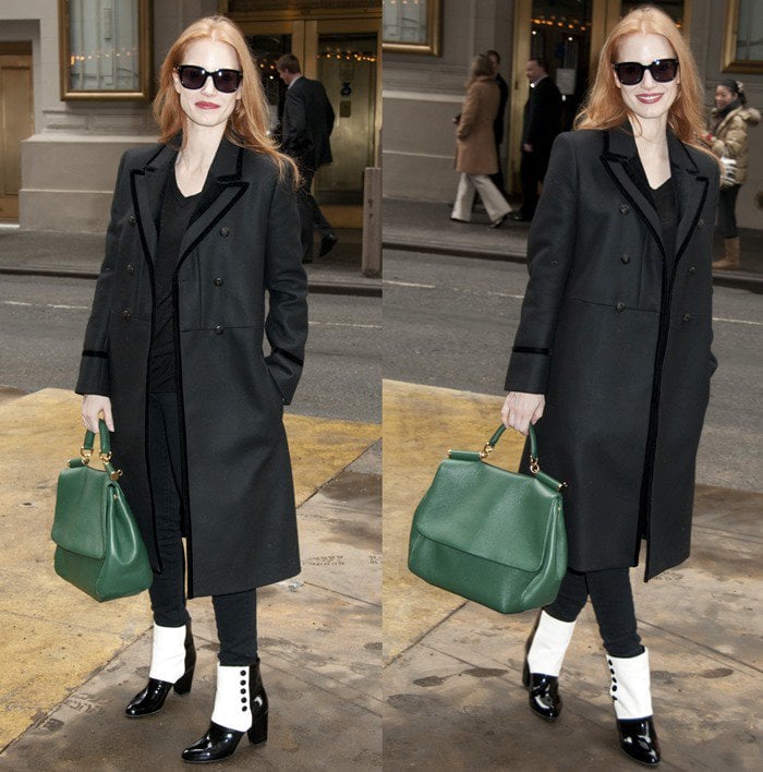 Jessica Chastain steps out in New York City wearing a tailored coat, dark sunglasses, and carrying an emerald green Dolce Gabbana Miss Sicily Soft Satchel