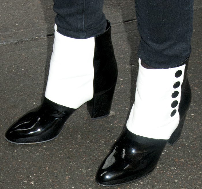 Close-up of Jessica Chastain’s two-tone Chanel spats-style ankle boots, featuring glossy black toes, white leather panels, and button detailing inspired by early 20th-century menswear