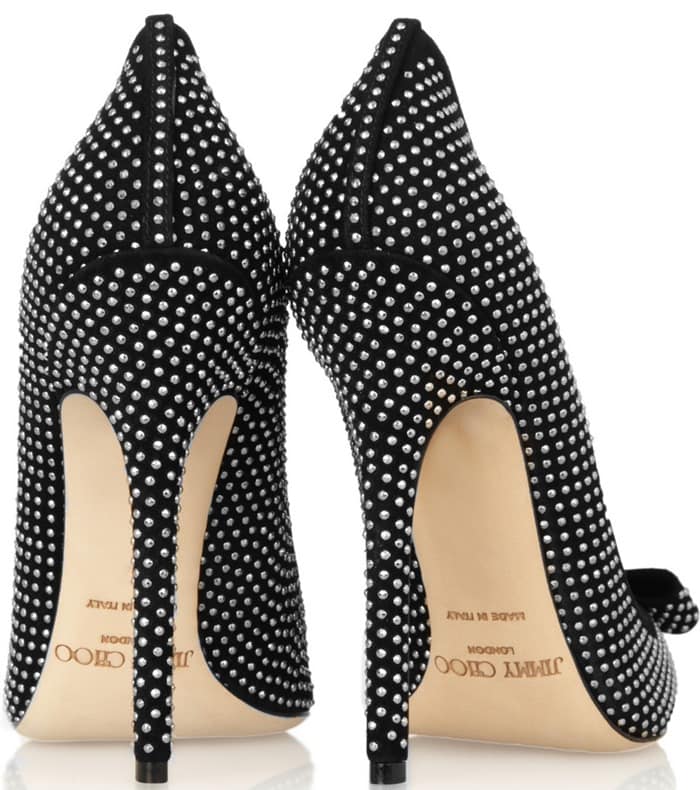 A rear view highlights the slim stiletto heel and fully studded silhouette of the Jimmy Choo “Maya” pumps, emphasizing their striking texture