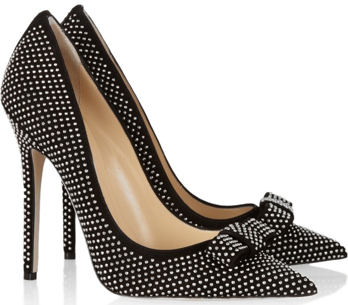 The Jimmy Choo “Maya” pumps showcase black suede covered in micro studs, finished with a feminine bow at the pointed toe