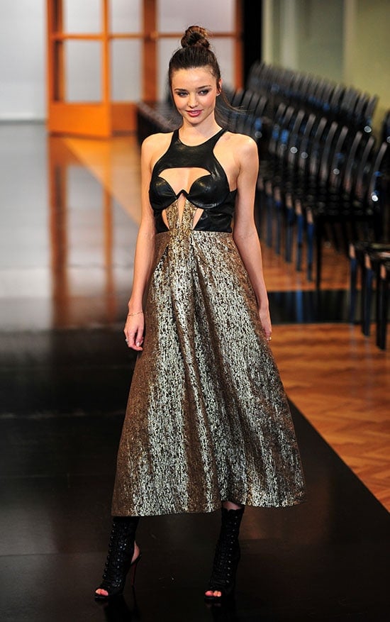 Miranda Kerr in a Willow Spring 2013 RTW bustier dress, pairing the dramatic cutout bodice and metallic skirt with sleek black heels that ground the look while keeping the focus on the sculptural silhouette