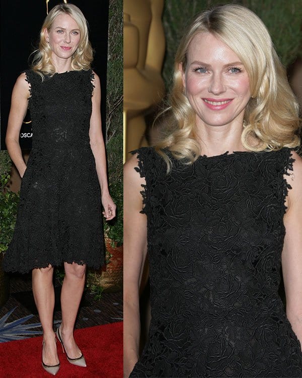 Naomi Watts wears a black lace Valentino dress with a flared skirt, paired with pointed-toe heels and soft waves for a timelessly elegant look