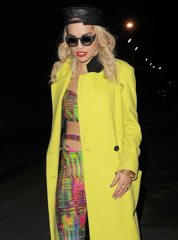 Embodying her fearless approach to style, Rita Ora steps out for an after-party, completing her vibrant ensemble with a sleek leather hat and cool sunglasses