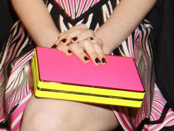 Sami Gayle holding a BCBGMAXAZRIA "Thea" clutch