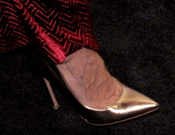 Sarah Jessica Parker's Gianvito Rossi pumps shine in a striking metallic gold finish, featuring a sleek pointed toe and stiletto heel that elevate her couture look